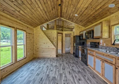 Blackberry model home kitchen equipped with granite countertops and black appliances.
