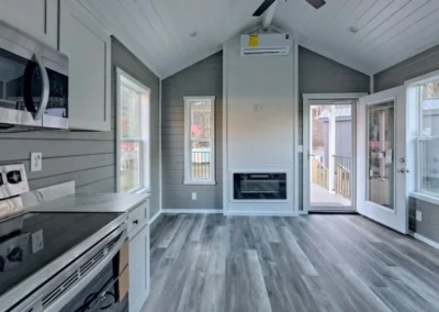 Partial view of a Savanna model home kitchen equipped with white cabinets and stainless steel appliances.